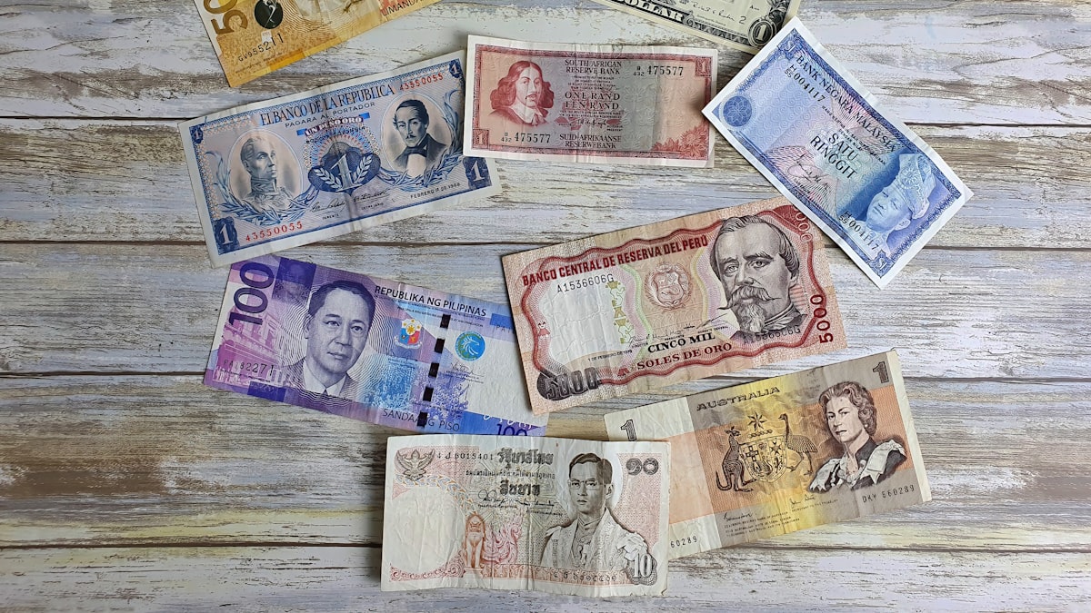 桌上摊开多个国家的纸币，象征 Wise 多币种账户与跨境换汇